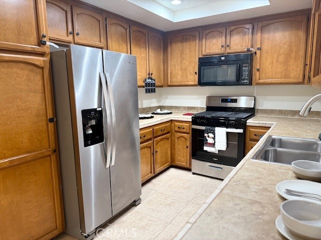 79740 Ave 42, Unit 5 Bermuda Dunes, CA 92203 - Photo 9 of 21 a kitchen with a refrigerator a stove and a sink