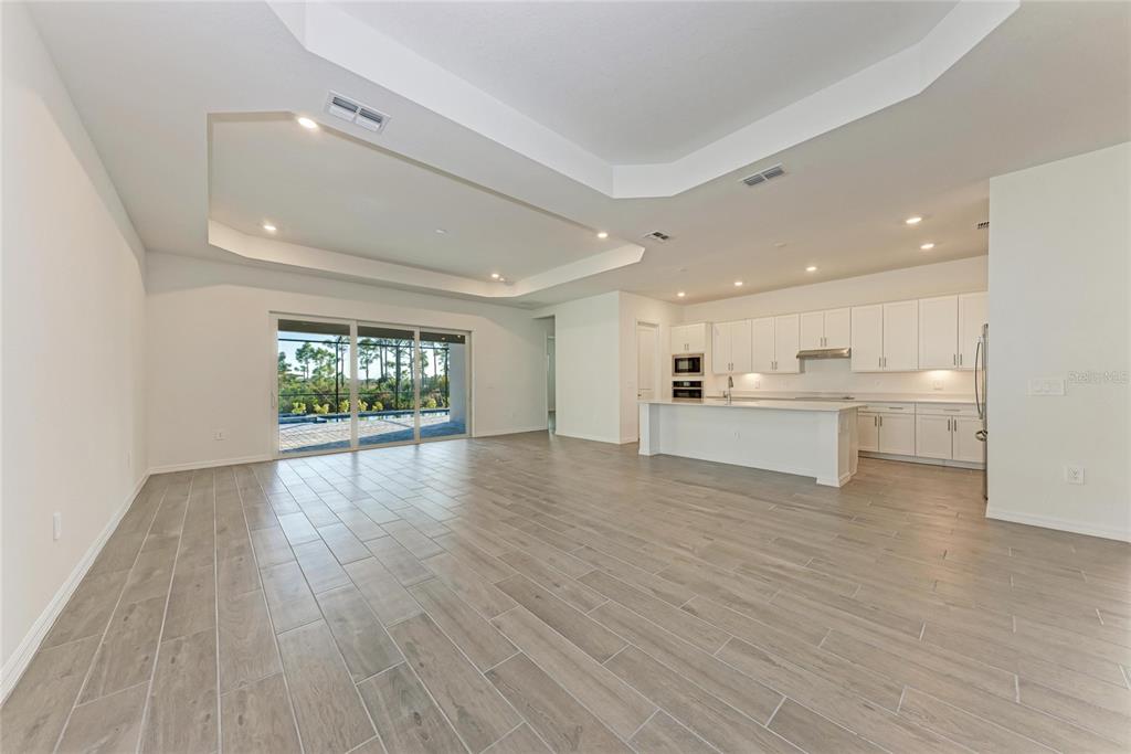 13021 Tulum Loop Venice, FL 34293 - Photo 13 of 66 a view of an empty room with wooden floor and a window
