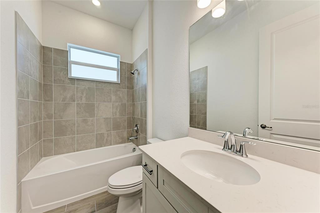 13021 Tulum Loop Venice, FL 34293 - Photo 21 of 66 a bathroom with a sink a toilet and shower