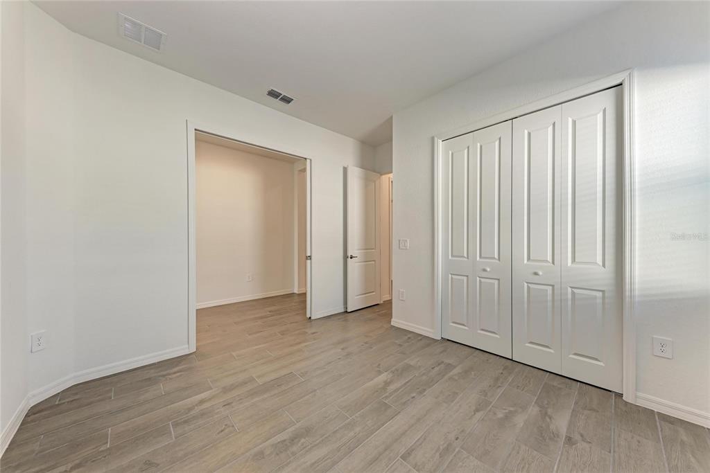 13021 Tulum Loop Venice, FL 34293 - Photo 23 of 66 a view of an empty room with wooden floor