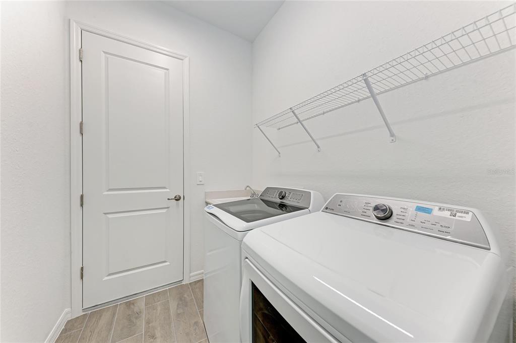 13021 Tulum Loop Venice, FL 34293 - Photo 28 of 66 a utility room with dryer and washer