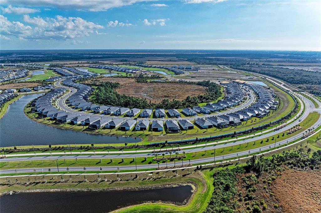 13021 Tulum Loop Venice, FL 34293 - Photo 36 of 66 a view of a swimming pool with a table and chairs in patio