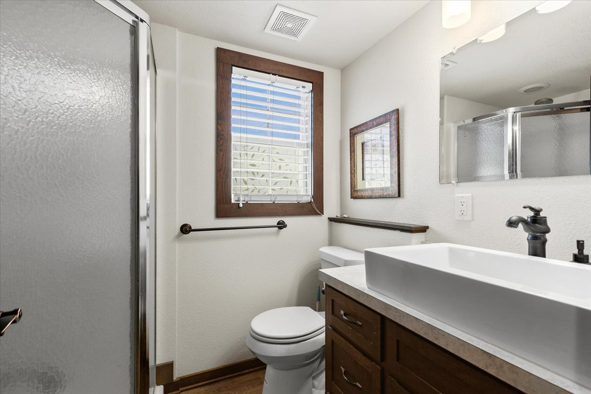 1705 Makinson Road West Point, TX 78963 - Photo 22 of 40 A well-lit bathroom features a large vanity, contemporary basin, and a separate shower.
