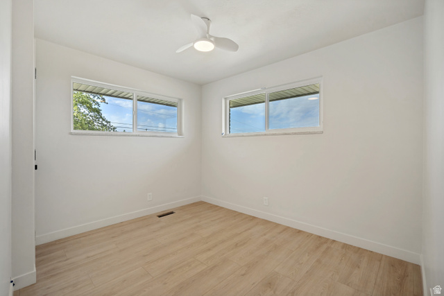 1168 East Center Street Bountiful, UT 84010 - Photo 22 of 38 Bright interior space featuring wood-finish flooring, white walls, and a contemporary ceiling fan with integrated lighting