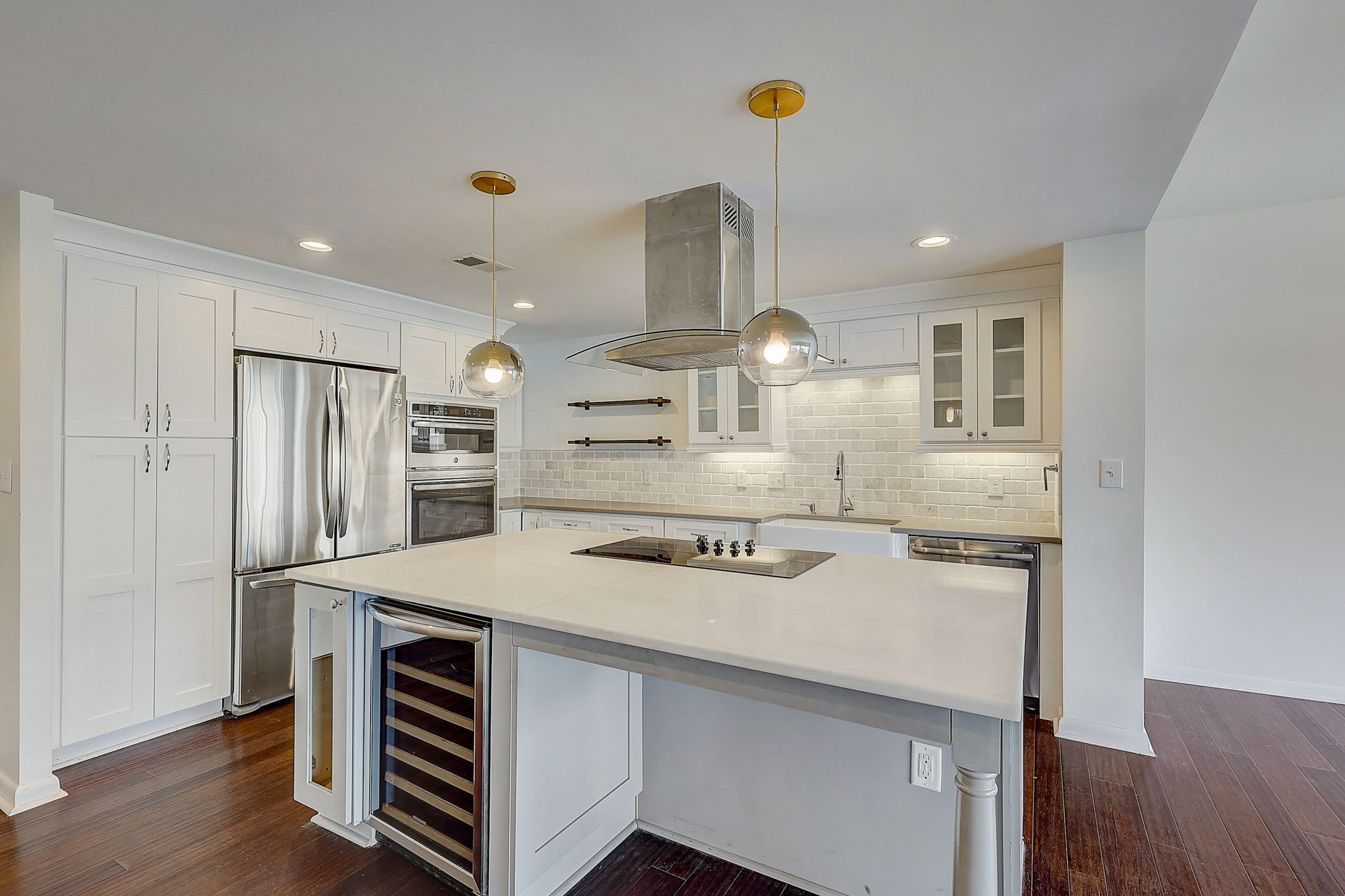 a kitchen with kitchen island stainless steel appliances a sink and wooden cabinets