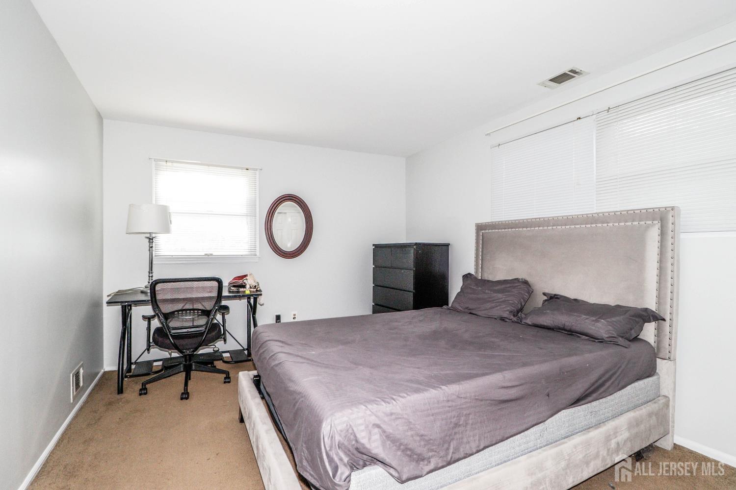 5 Timothy Court Edison, NJ 08837 - Photo 26 of 32 a bedroom with a bed a table and chair