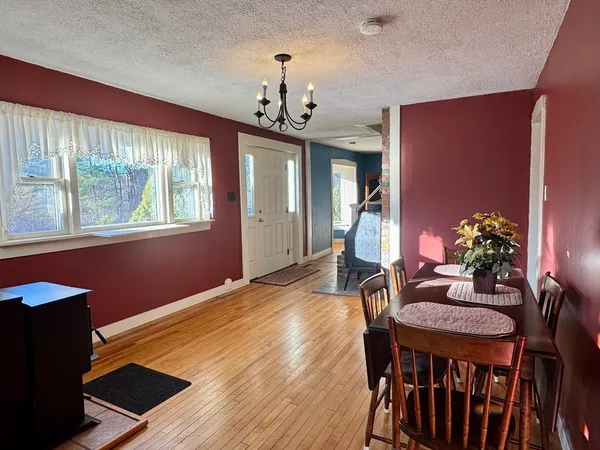 a view of a dining room with furniture and a chandelier