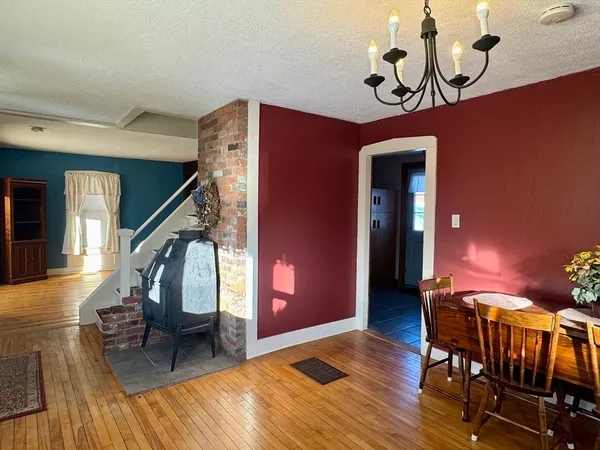 a view of a dining room with furniture wooden floor and chandelier