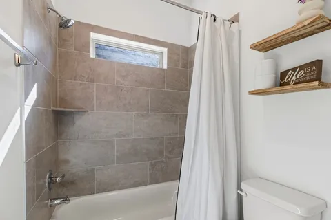 a bathroom with a shower and a toilet