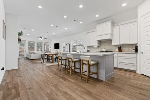 a kitchen with a table chairs refrigerator and cabinets