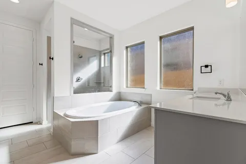 a bathroom with a bathtub and a sink