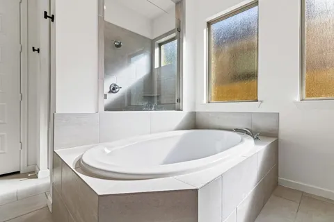 a bath tub sitting next to a window