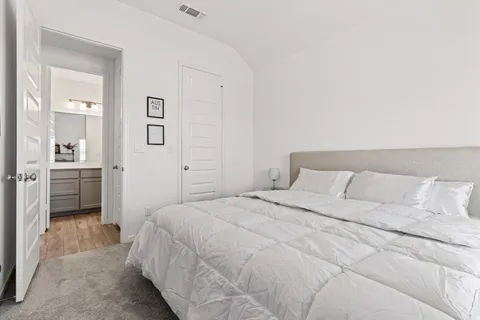 a bedroom with a bed and a view of bathroom