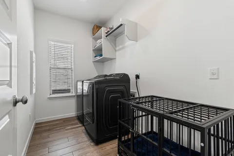 a view of a hallway with furniture and wooden floor