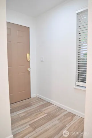 a view of a room with wooden floor