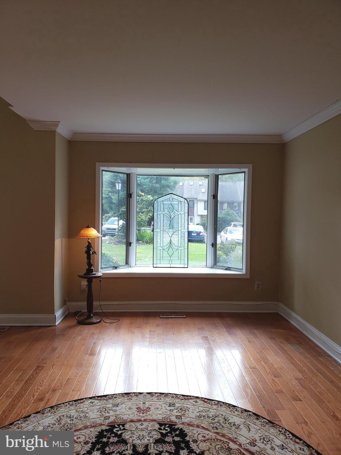 504 Williamson Circle Media, PA 19063 - Photo 4 of 33 an empty room with wooden floor and a window