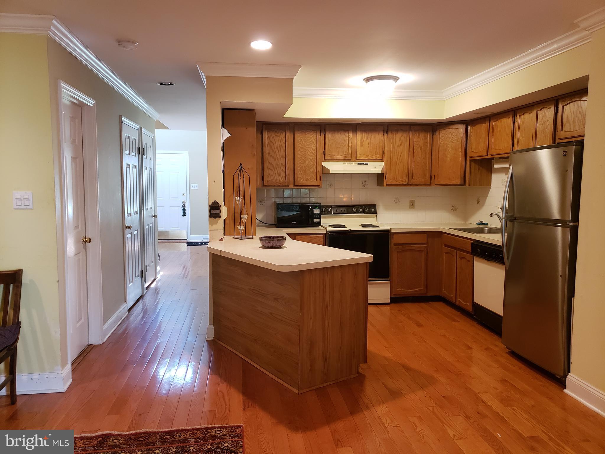 504 Williamson Circle Media, PA 19063 - Photo 7 of 33 a kitchen with wooden floors appliances and cabinets