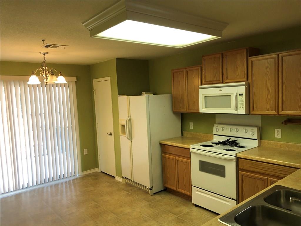 6912 Walkup Lane Austin, TX 78747 - Photo 11 of 14 a kitchen with a stove a sink and a window