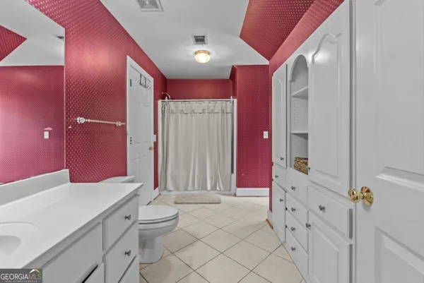 a view of a patio with a table chairs and wooden floor