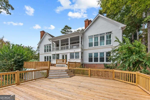 a view of a house with a wooden deck