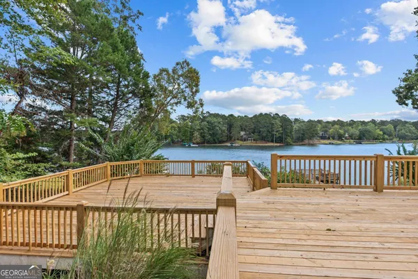 an aerial view of a house with a yard and lake view