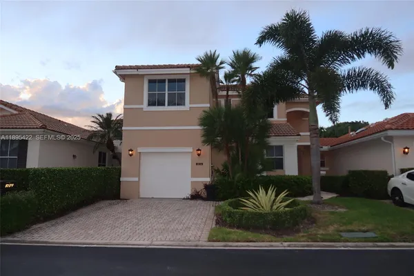 a house that has a palm tree in front of it