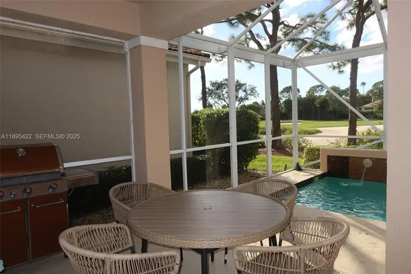 a living room with furniture and a floor to ceiling window