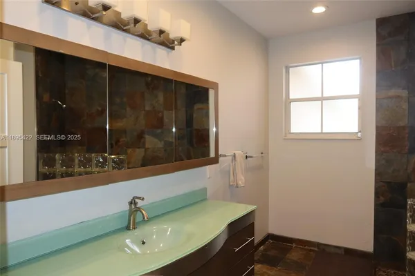 a bathroom with a sink and a mirror