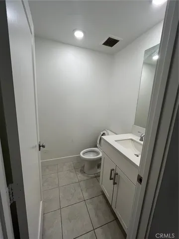 a bathroom with a toilet a sink a shower and mirror