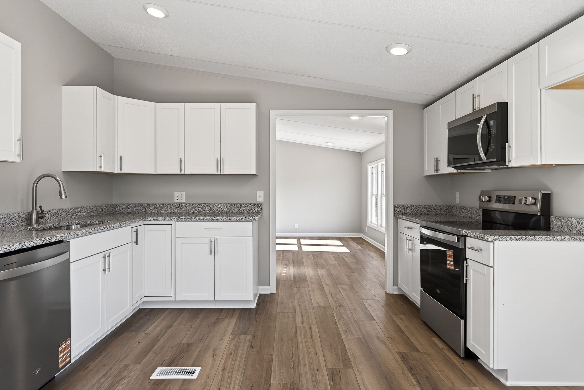 593 Cedar Bend Road Beechgrove, TN 37018 - Photo 11 of 38 a kitchen with granite countertop cabinets stainless steel appliances and wooden floor
