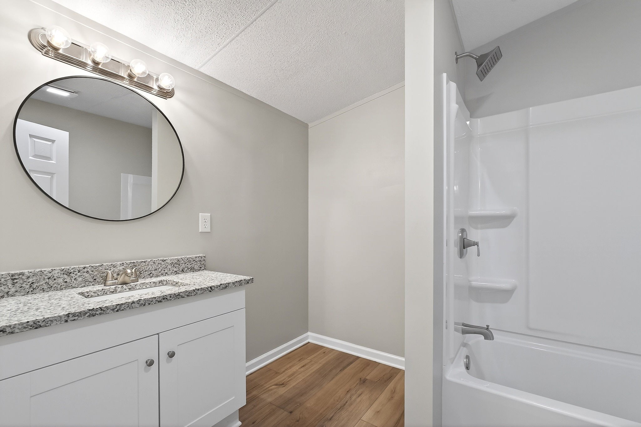 593 Cedar Bend Road Beechgrove, TN 37018 - Photo 18 of 38 a bathroom with a granite countertop sink mirror vanity and a bathtub