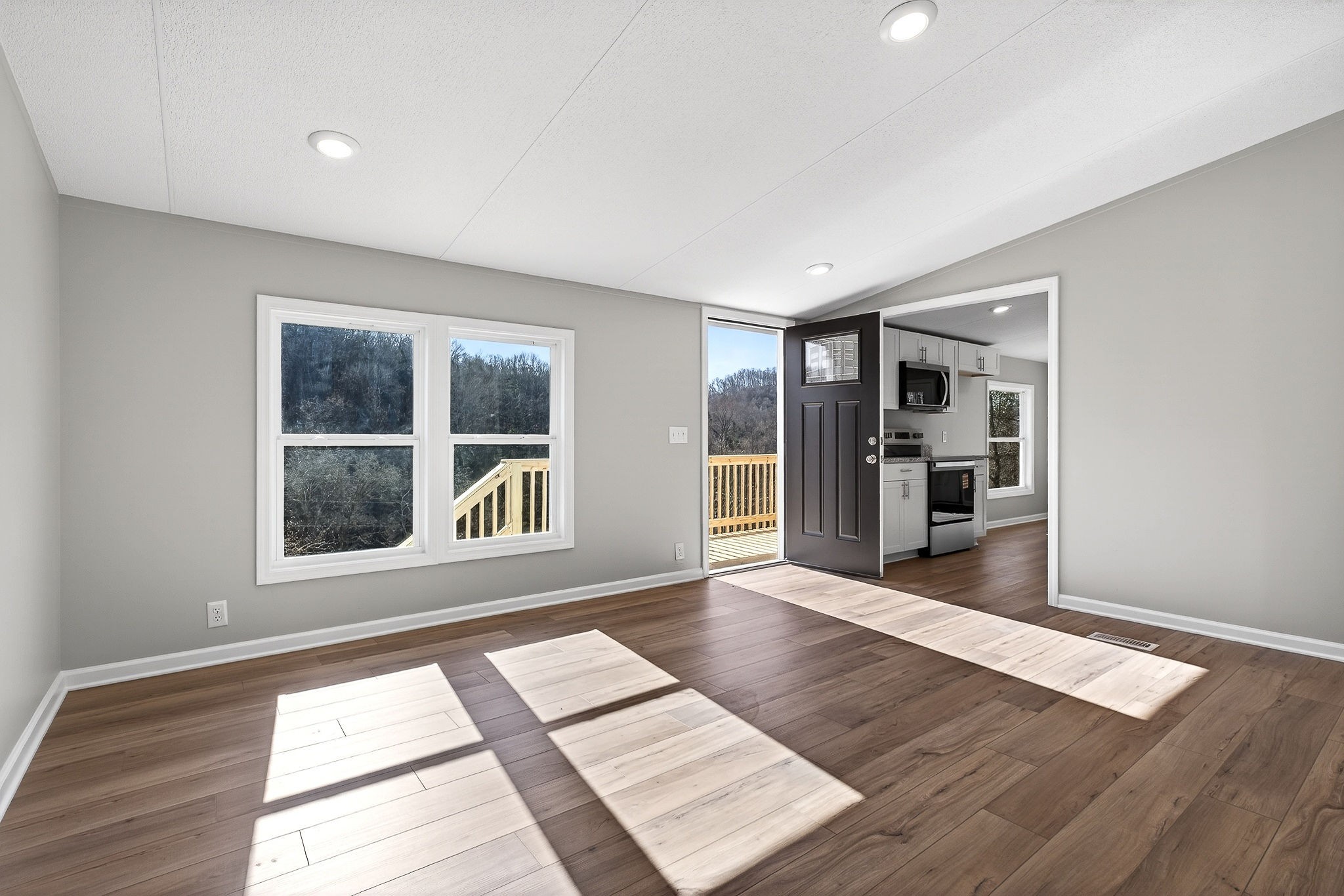 593 Cedar Bend Road Beechgrove, TN 37018 - Photo 4 of 38 a view of an empty room with wooden floor and a window