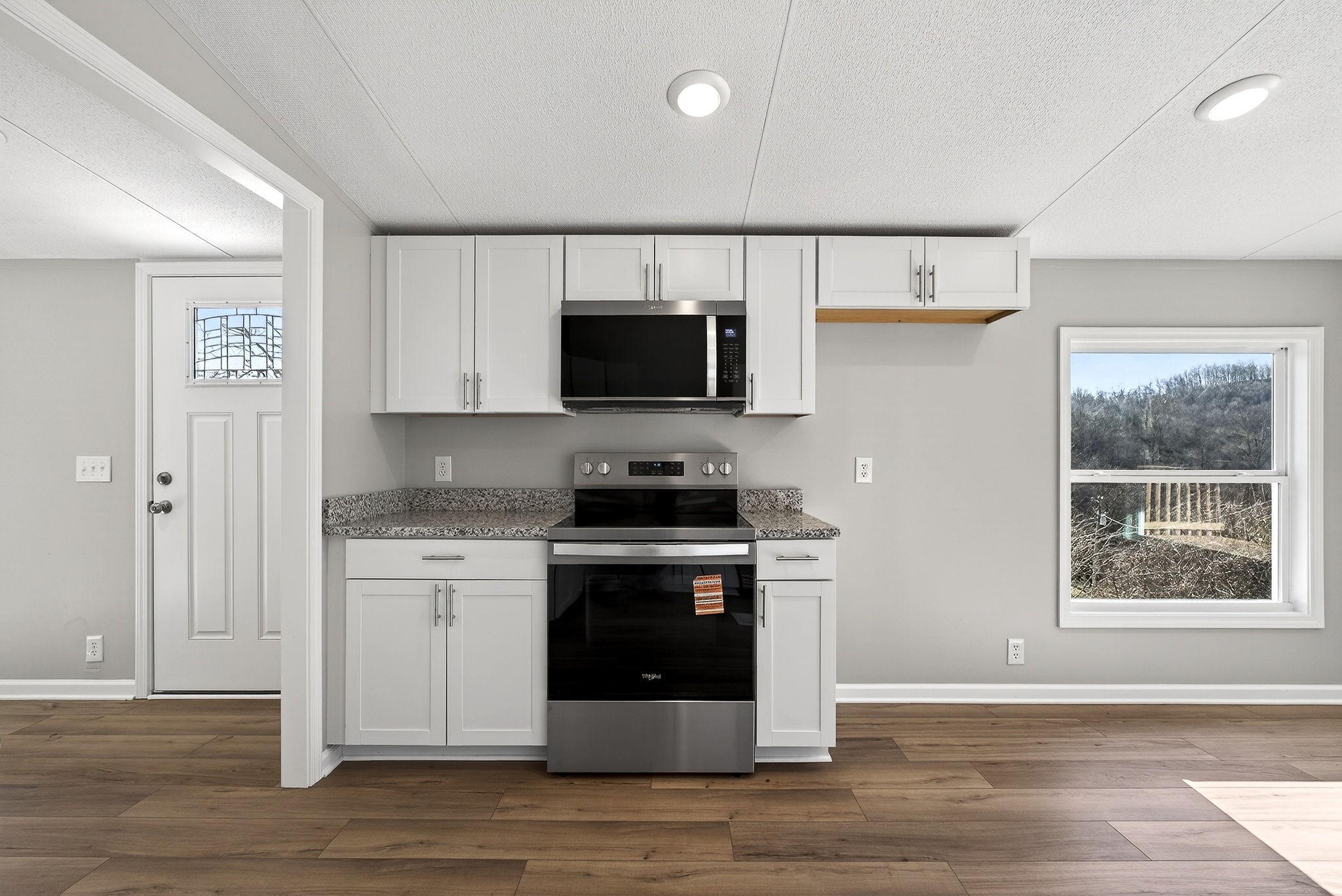 593 Cedar Bend Road Beechgrove, TN 37018 - Photo 10 of 38 a kitchen with stainless steel appliances granite countertop a stove a sink and a microwave