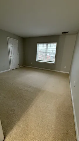 an empty room with a empty space and windows