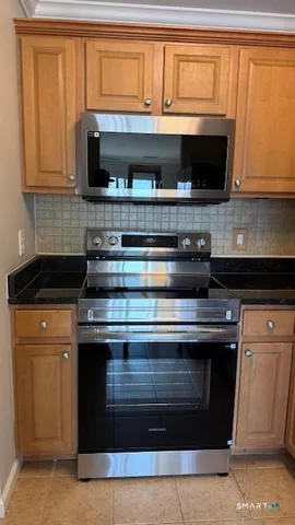a stove top oven sitting inside of a kitchen
