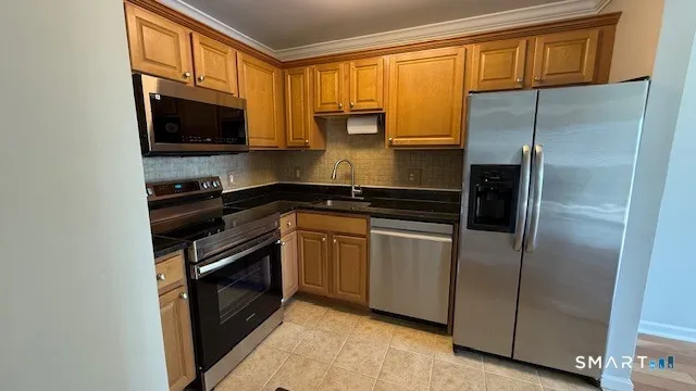 a kitchen with a refrigerator stove and microwave