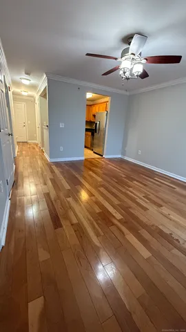 a view of empty room with wooden floor