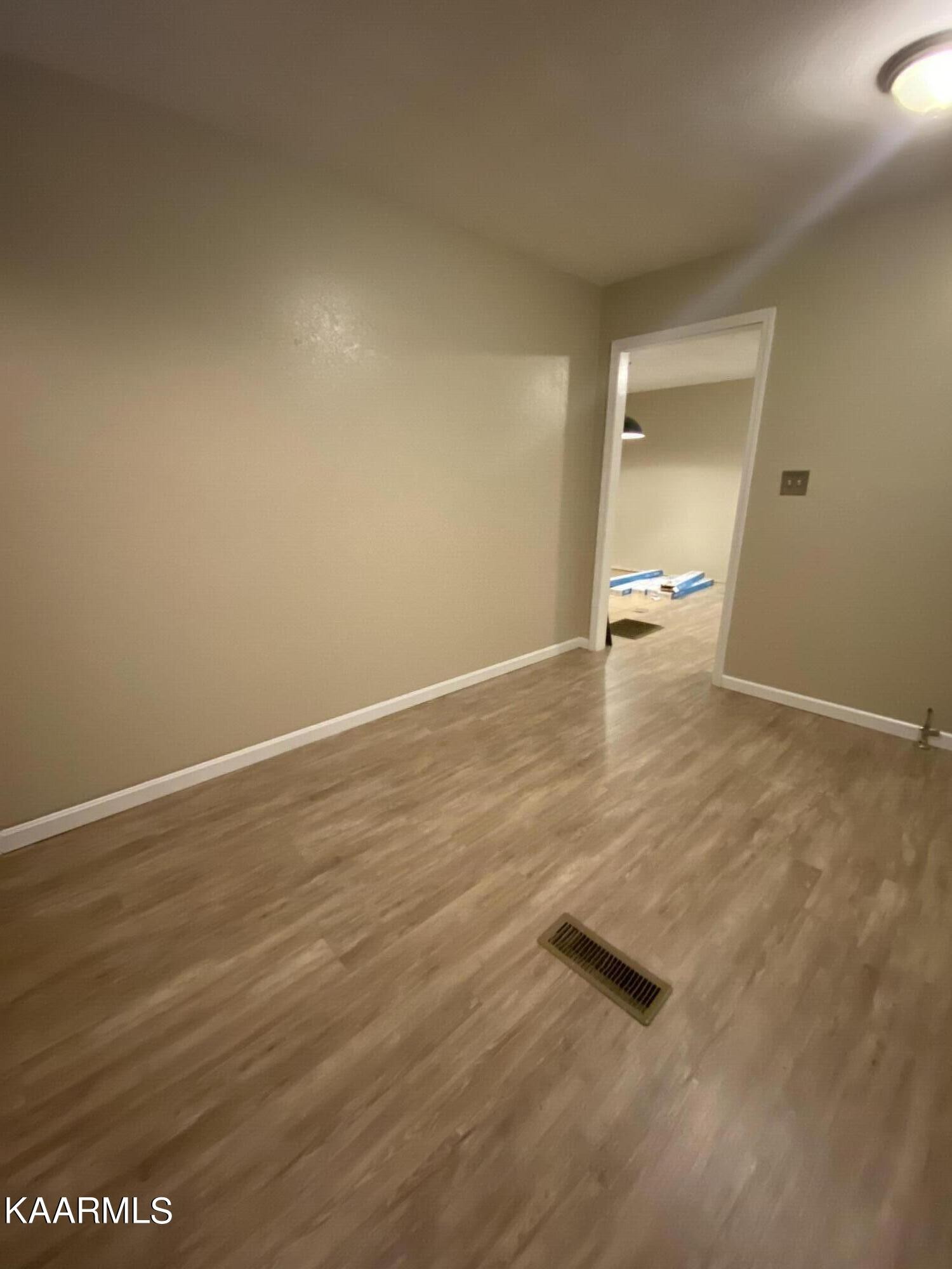 3575 Foundry Hill Road Puryear, TN 38251 - Photo 2 of 13 an empty room with wooden floor and windows