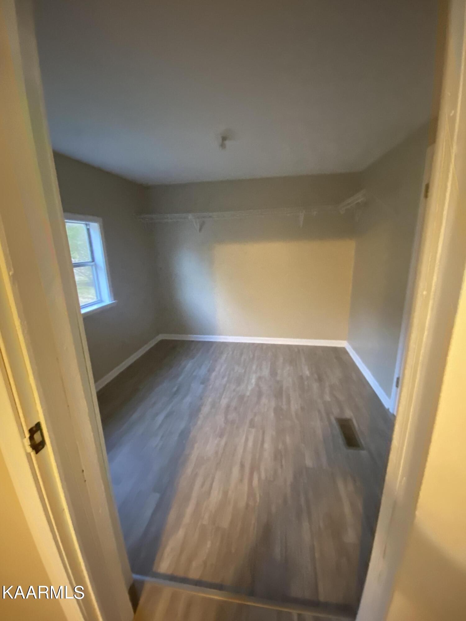 3575 Foundry Hill Road Puryear, TN 38251 - Photo 7 of 13 wooden floor in an empty room with a window
