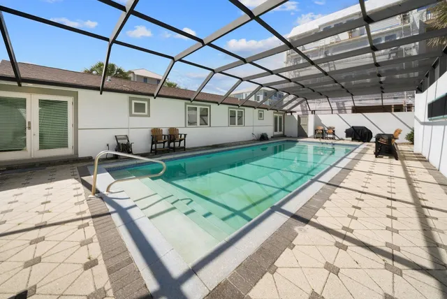 a view of a porch with furniture and a yard