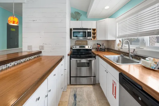 a kitchen that has a sink and a stove