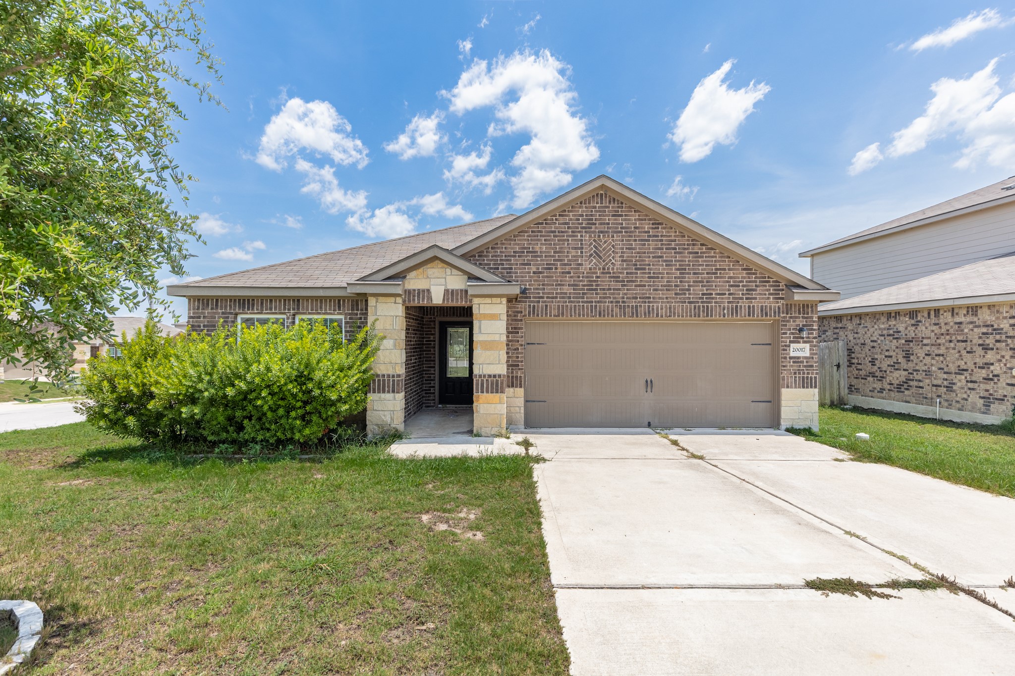 20017 Hubert R Humphrey Road Manor, TX 78653 - Photo 1 of 35 Brick and stone accents adorn this charming single-story residence with an attached garage.