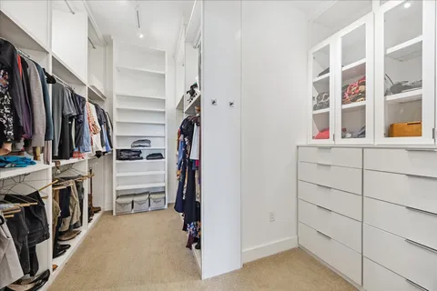 a view of a hallway and wooden floor