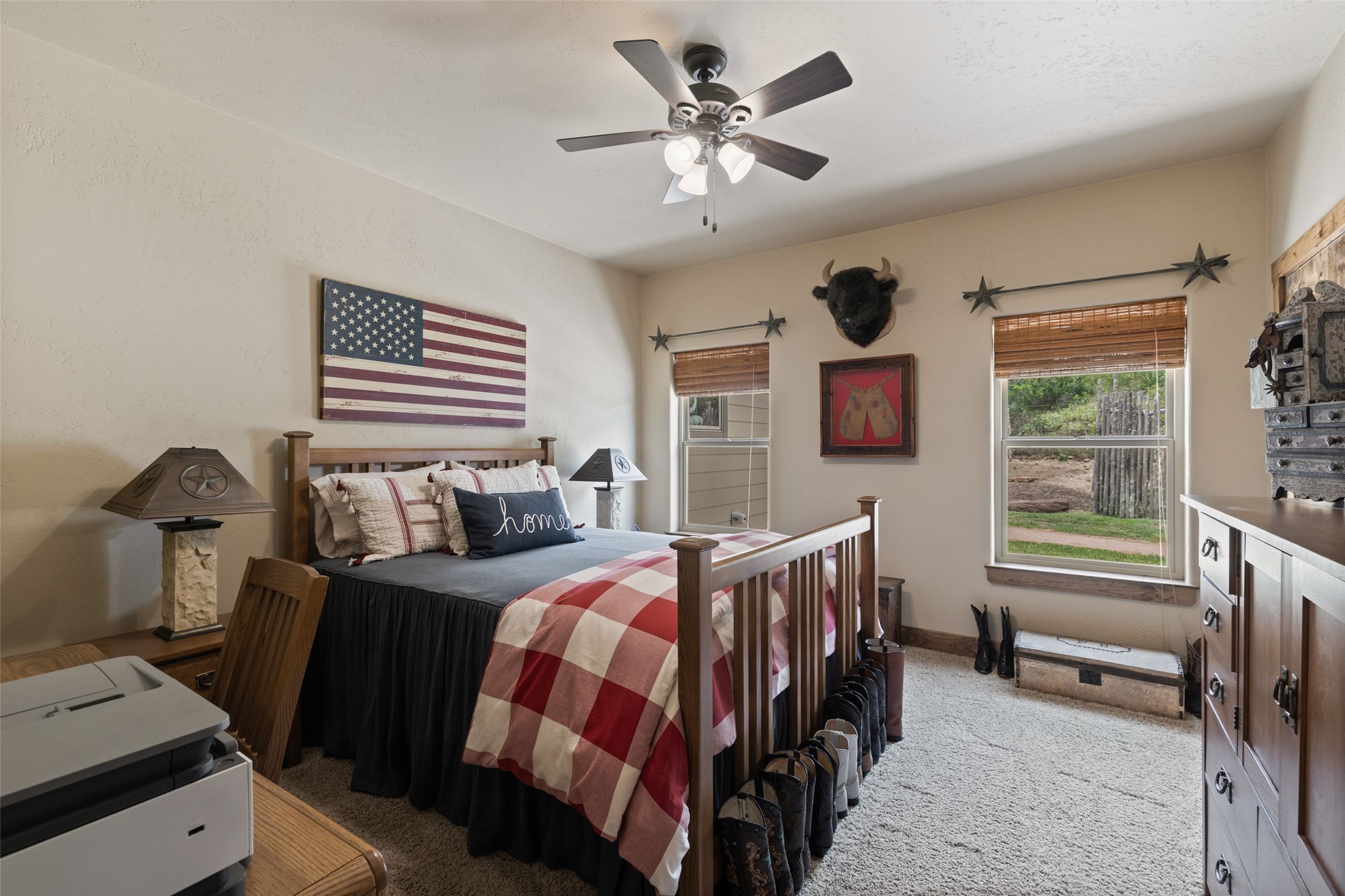 8400 Ranch Road 1431 Marble Falls, TX 78654 - Photo 29 of 30 Well-lit sleeping quarters with a ceiling fan, ample natural light, and plush carpeting for comfort.