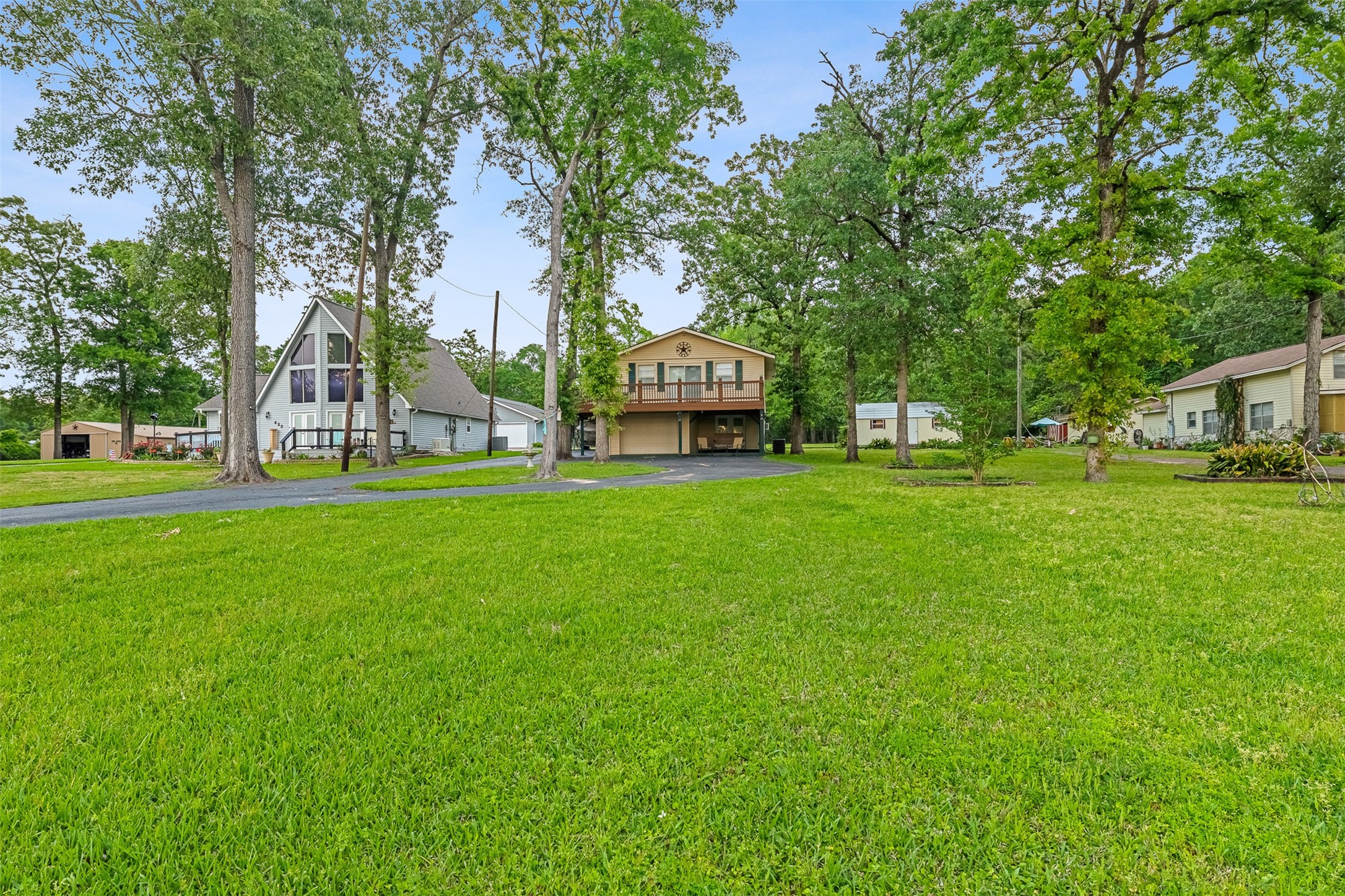 439 Lakeview Harbor Onalaska, TX 77360 - Photo 37 of 43 a front view of a house with a garden and trees