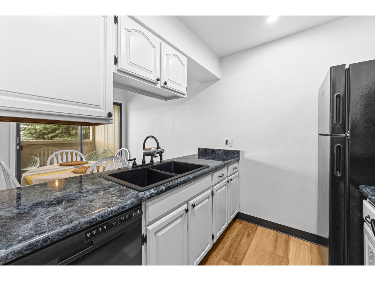 3400 Stanford Road, Unit B223 Fort Collins, CO 80525 - Photo 14 of 34 a kitchen with stainless steel appliances granite countertop a sink and a refrigerator