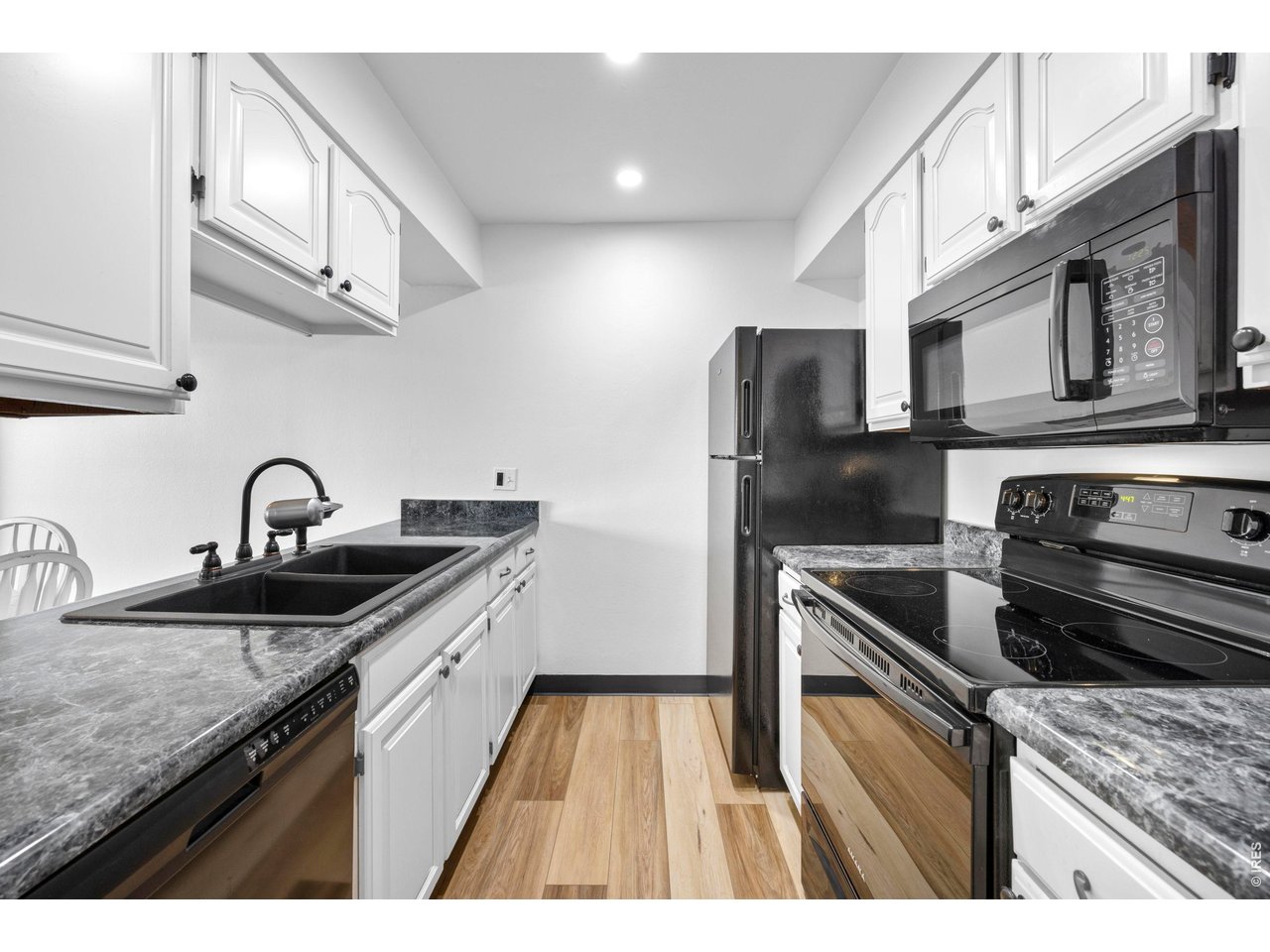 3400 Stanford Road, Unit B223 Fort Collins, CO 80525 - Photo 17 of 34 a kitchen with stainless steel appliances granite countertop a sink stove and refrigerator