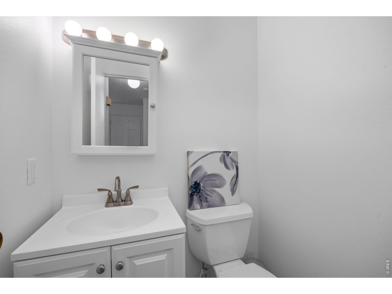 3400 Stanford Road, Unit B223 Fort Collins, CO 80525 - Photo 20 of 34 a bathroom with a toilet sink and mirror