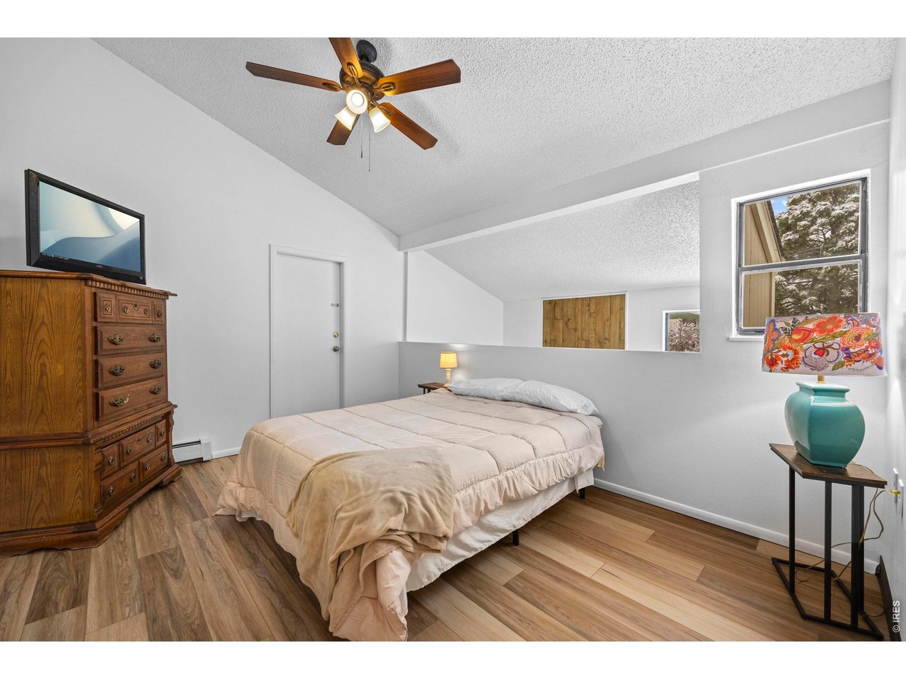 3400 Stanford Road, Unit B223 Fort Collins, CO 80525 - Photo 22 of 34 a bedroom with a bed and a chandelier