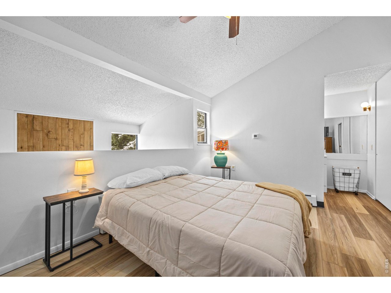 3400 Stanford Road, Unit B223 Fort Collins, CO 80525 - Photo 23 of 34 a bedroom with a bed and a painting on the wall